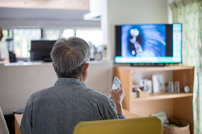 テレビを見る高齢男性の写真
